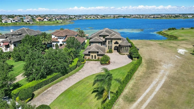 drone / aerial view featuring a residential view and a water view