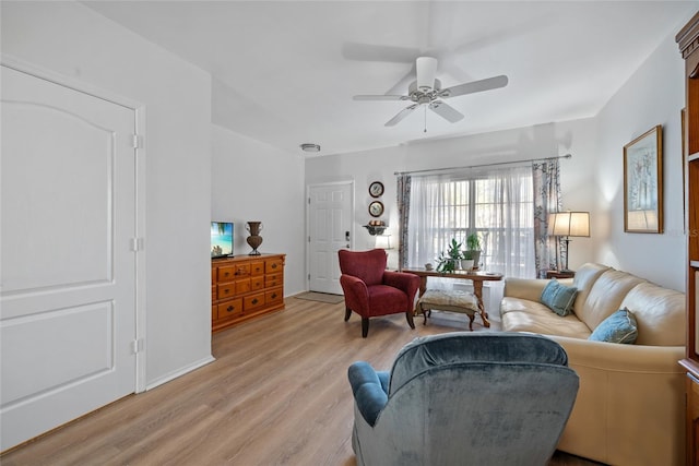 living room featuring light wood-type flooring and a ceiling fan