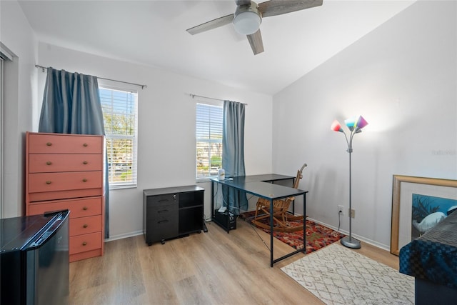 office space with lofted ceiling, baseboards, ceiling fan, and light wood finished floors