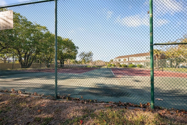 view of sport court featuring fence