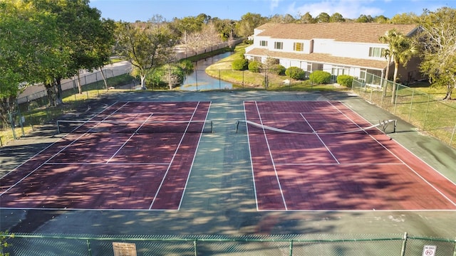 view of tennis court featuring fence