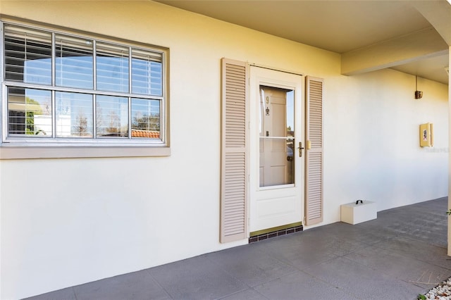 doorway to property with stucco siding