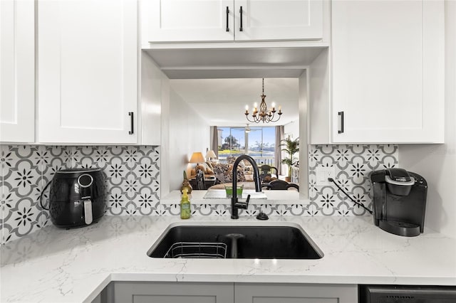 19029 US Highway 19 N Unit 7-9, Clearwater, FL 33764 - kitchen featuring dishwasher, an inviting chandelier, a sink, and white cabinets