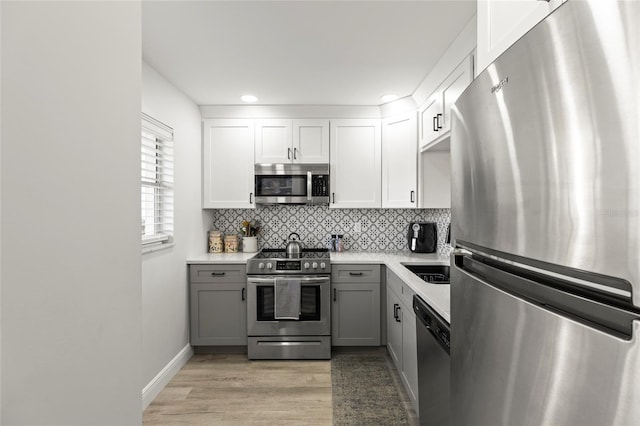 19029 US Highway 19 N Unit 7-9, Clearwater, FL 33764 - kitchen with stainless steel appliances, decorative backsplash, light countertops, and gray cabinetry