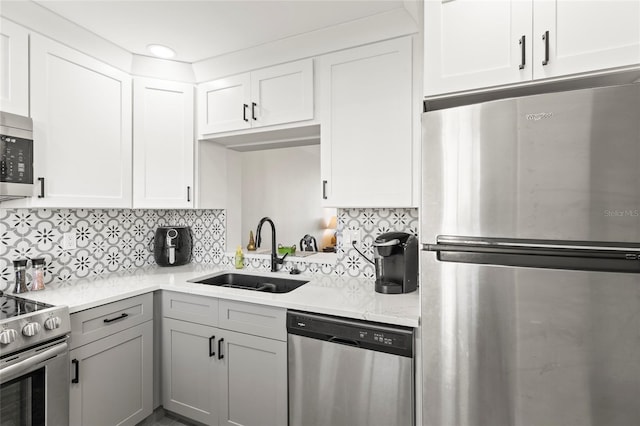 19029 US Highway 19 N Unit 7-9, Clearwater, FL 33764 - kitchen with stainless steel appliances, white cabinetry, a sink, and tasteful backsplash