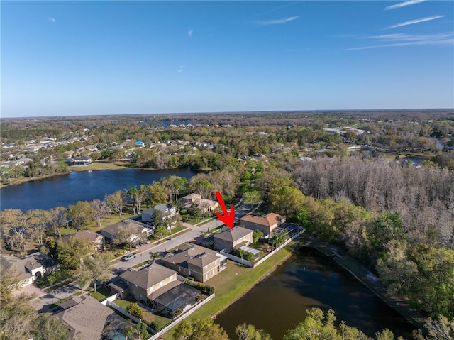 birds eye view of property with a water view, a wooded view, and a residential view