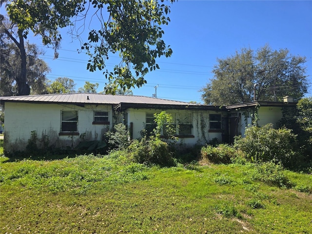 rear view of house with metal roof