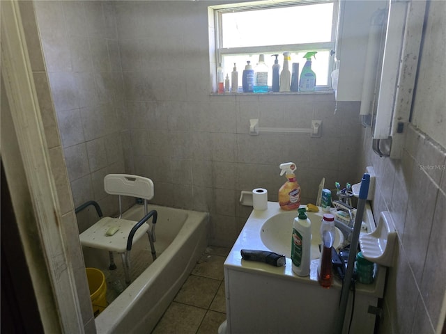 full bathroom with a tub to relax in, tile patterned flooring, tile walls, and vanity