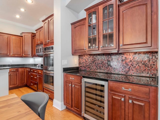 kitchen featuring stainless steel appliances, wine cooler, crown molding, and light wood finished floors