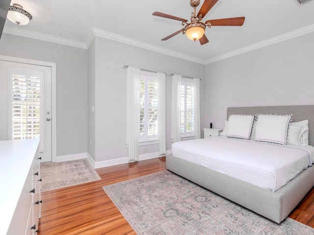 bedroom featuring baseboards, light wood-style flooring, a ceiling fan, and ornamental molding