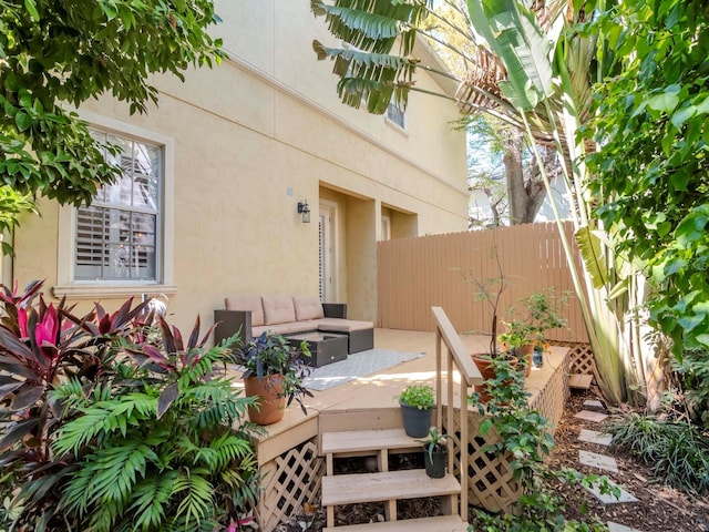 view of patio / terrace featuring an outdoor living space, a deck, and fence