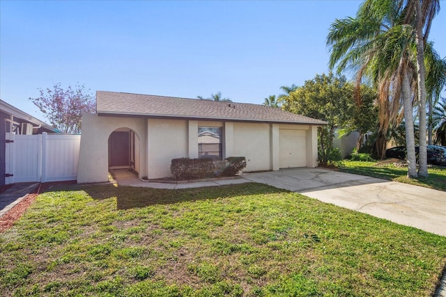 ranch-style house with concrete driveway, a garage, a front lawn, and stucco siding