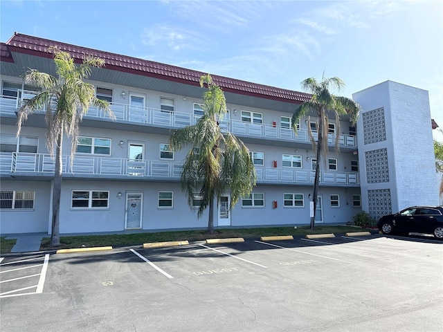 view of building exterior with uncovered parking