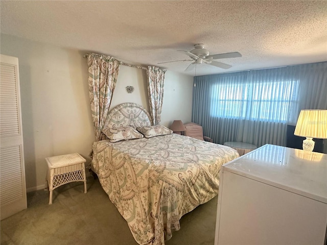 bedroom with carpet, ceiling fan, and a textured ceiling