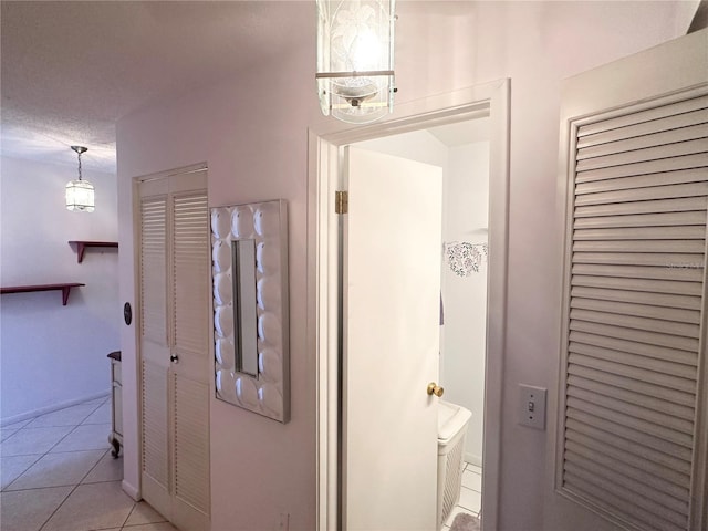 bathroom with tile patterned flooring and a textured ceiling