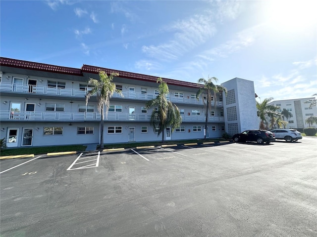 view of building exterior with uncovered parking