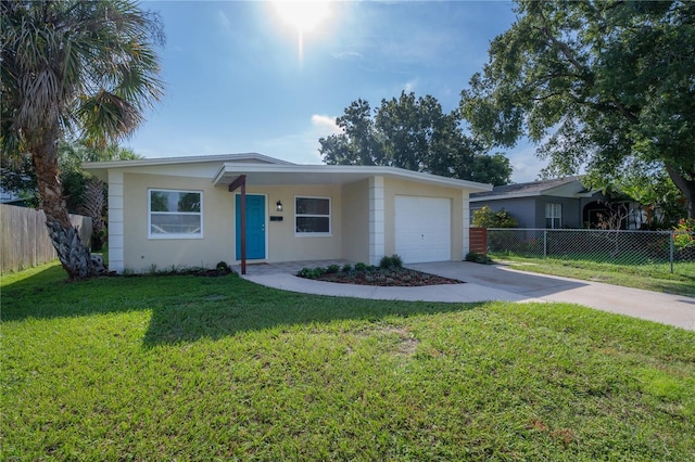 ranch-style house featuring a garage, fence, concrete driveway, stucco siding, and a front yard