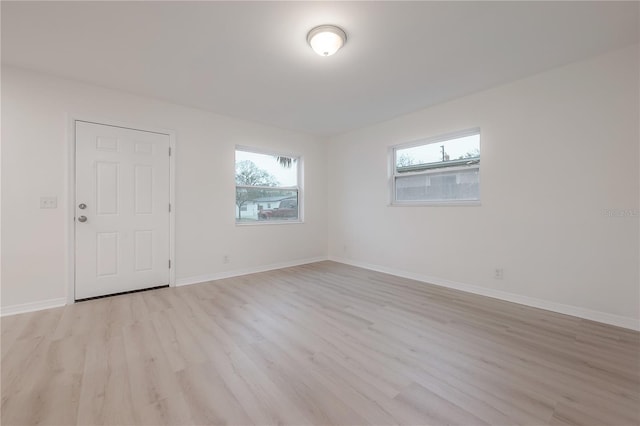 empty room featuring light wood-style floors and baseboards