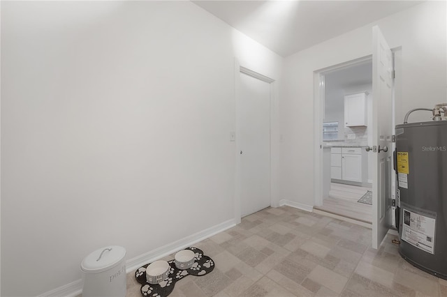 utility room featuring water heater