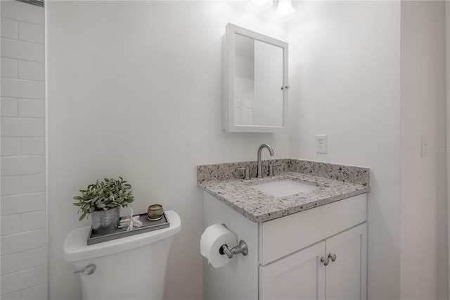 bathroom featuring toilet and vanity