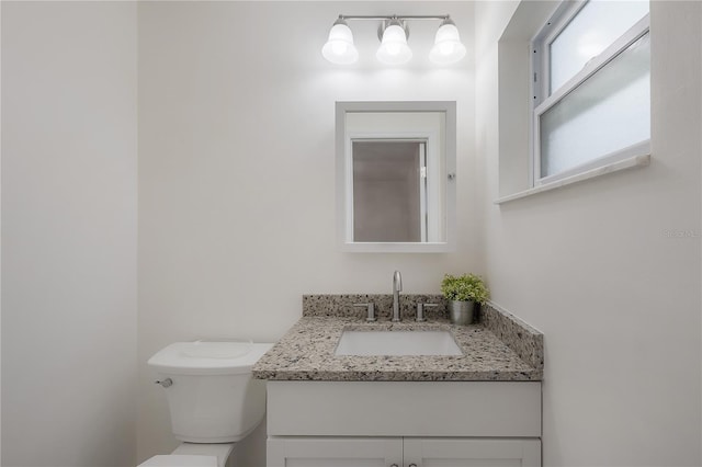 bathroom with toilet and vanity