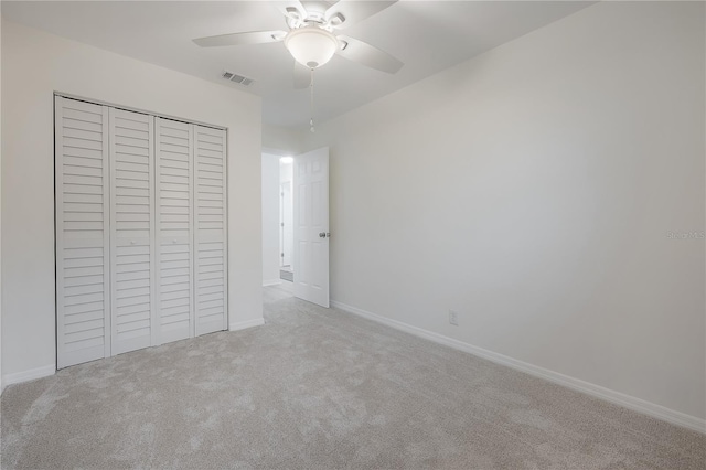 unfurnished bedroom featuring ceiling fan, visible vents, baseboards, a closet, and carpet