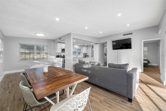 dining area with recessed lighting, visible vents, light wood-style flooring, and baseboards