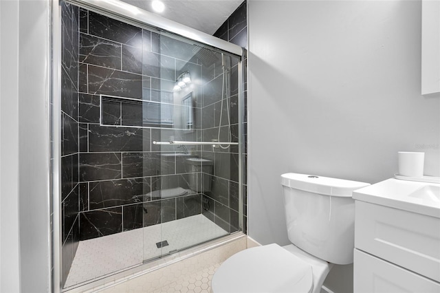 bathroom featuring a stall shower, vanity, and toilet