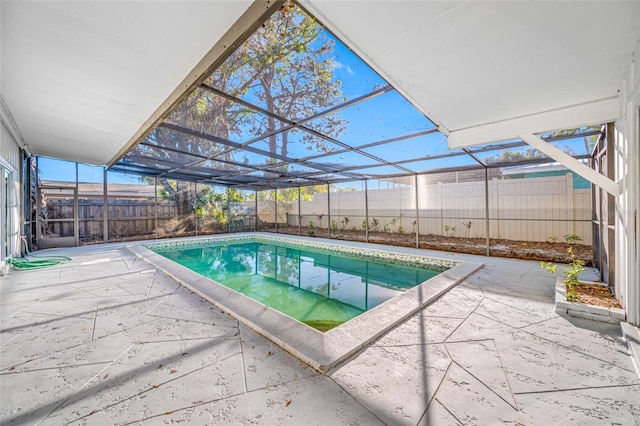 view of swimming pool with a fenced in pool, glass enclosure, a patio area, and a fenced backyard