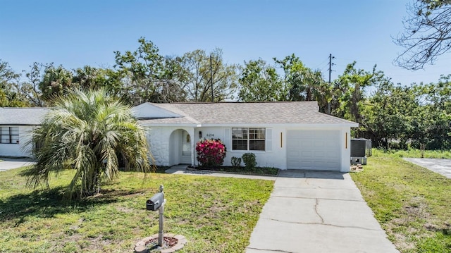 ranch-style home with an attached garage, a front yard, stucco siding, cooling unit, and driveway