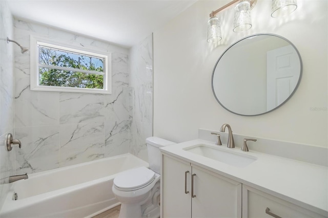 bathroom featuring toilet, vanity, and  shower combination