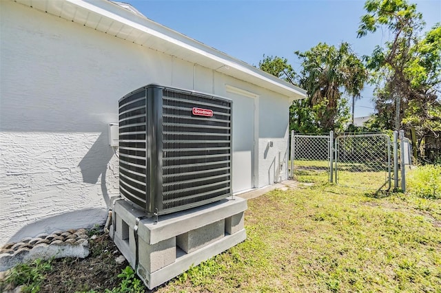 exterior details featuring cooling unit, fence, and a gate