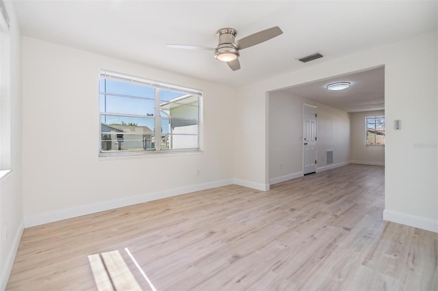 spare room with a wealth of natural light, visible vents, and light wood-style flooring