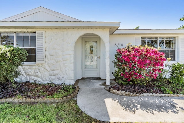 property entrance with stone siding