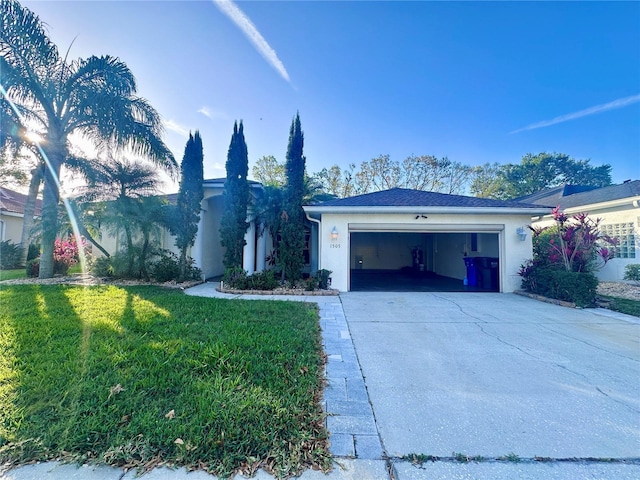 ranch-style house featuring a garage, driveway, a front lawn, and stucco siding