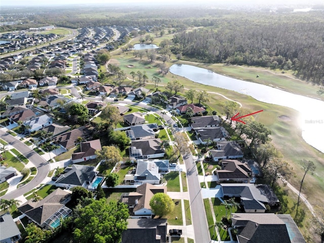 bird's eye view with view of golf course, a water view, and a residential view