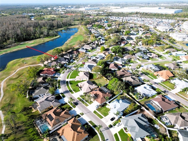 drone / aerial view featuring a water view and a residential view