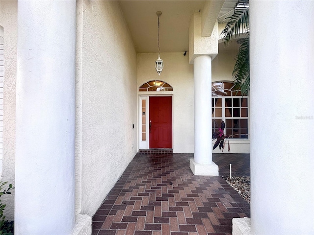 doorway to property featuring stucco siding