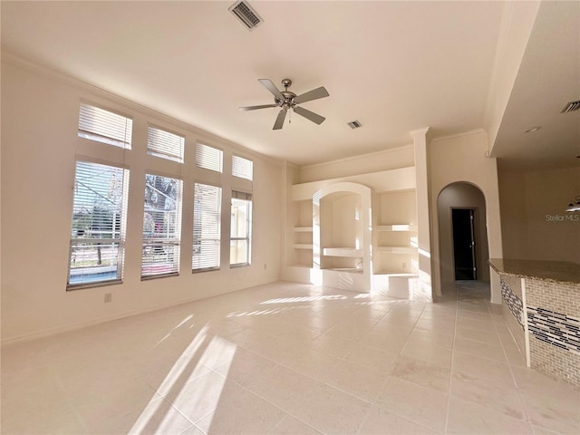 unfurnished living room featuring built in shelves, visible vents, ceiling fan, and light tile patterned floors