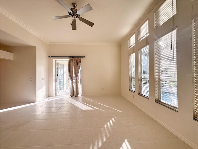 empty room featuring ornamental molding, light tile patterned flooring, ceiling fan, and baseboards