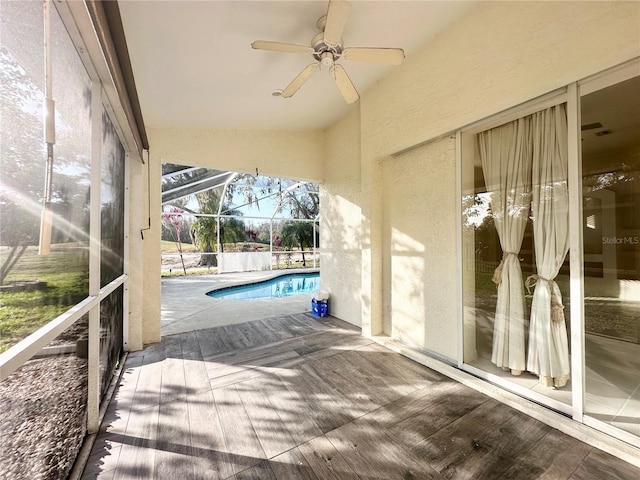 view of patio / terrace with an outdoor pool, a lanai, and ceiling fan