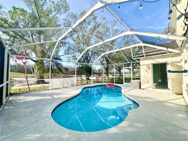 outdoor pool with a lanai and a patio