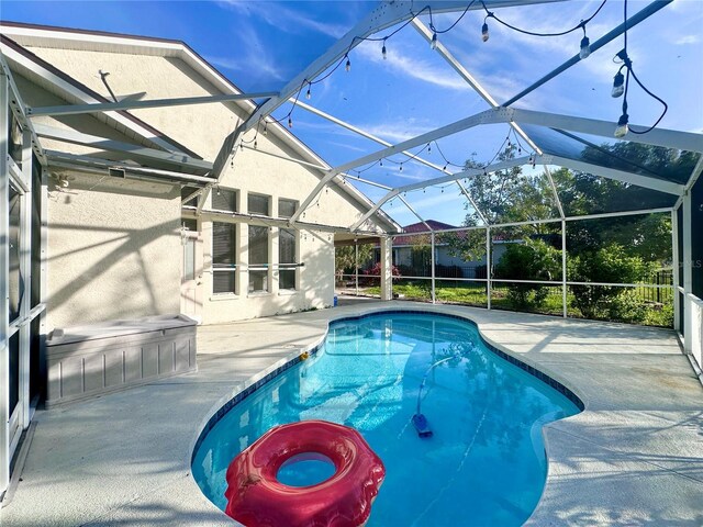 view of swimming pool with a fenced in pool, a lanai, and a patio area