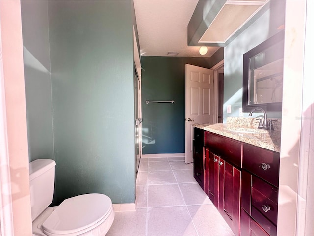 full bath featuring toilet, tile patterned flooring, baseboards, and vanity