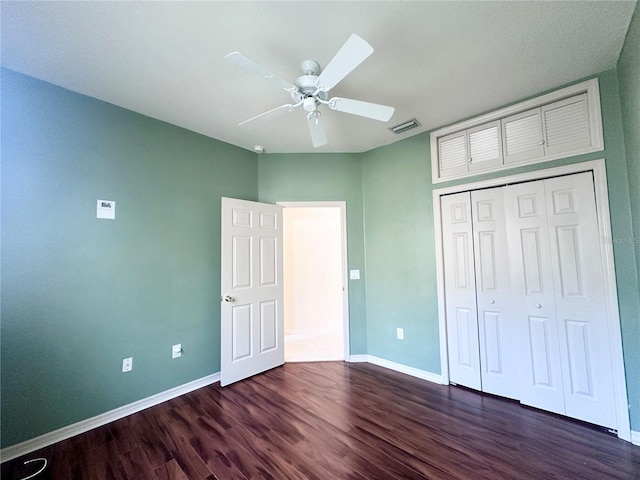 unfurnished bedroom featuring a closet, wood finished floors, a ceiling fan, and baseboards