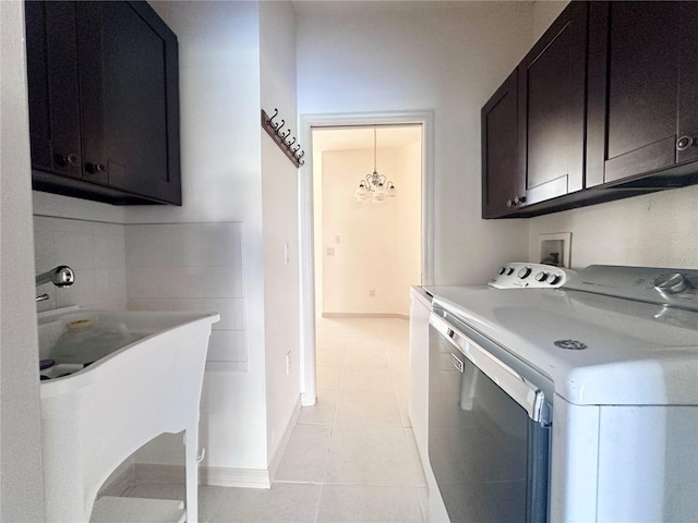 laundry room with baseboards, cabinet space, separate washer and dryer, and light tile patterned flooring