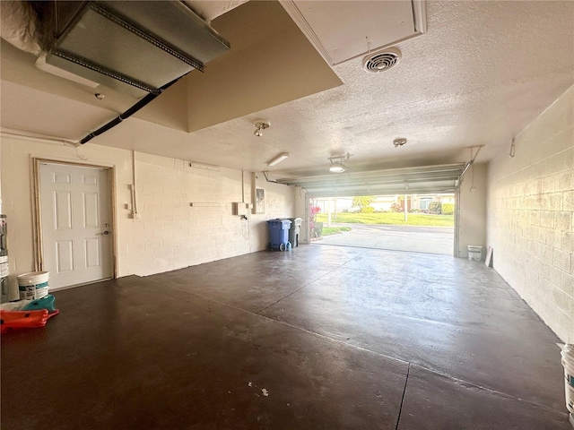 garage featuring visible vents and concrete block wall