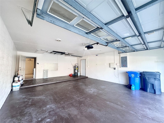 garage featuring electric panel, concrete block wall, electric water heater, and a garage door opener