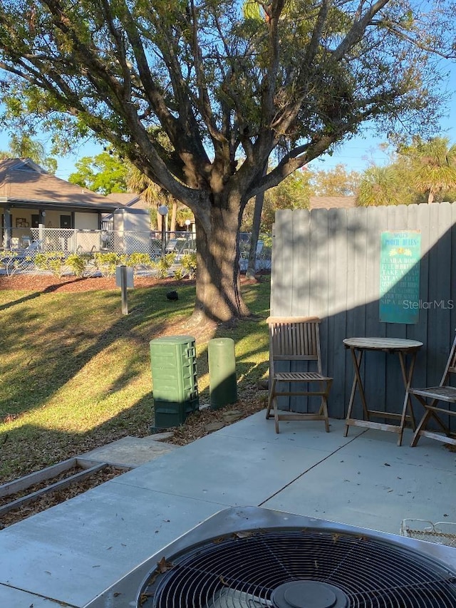 view of patio featuring central AC and fence