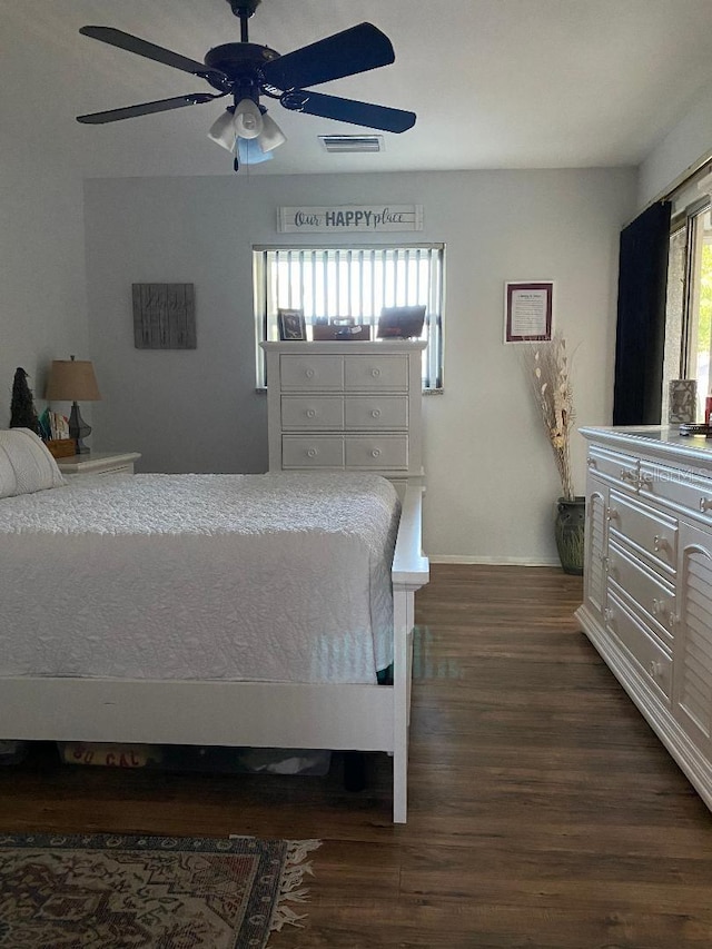 bedroom featuring dark wood-style flooring, visible vents, and ceiling fan